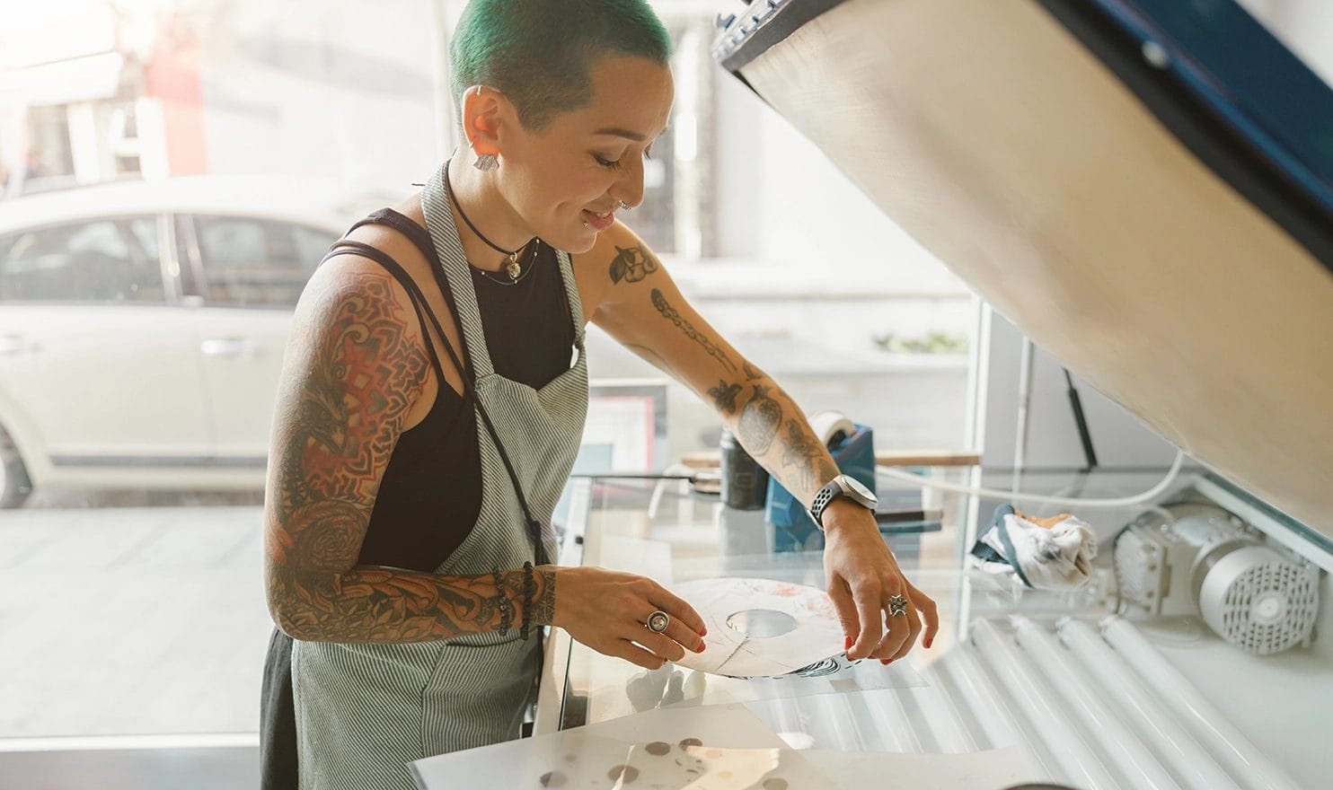 A female creative is preparing to screen print her artwork.