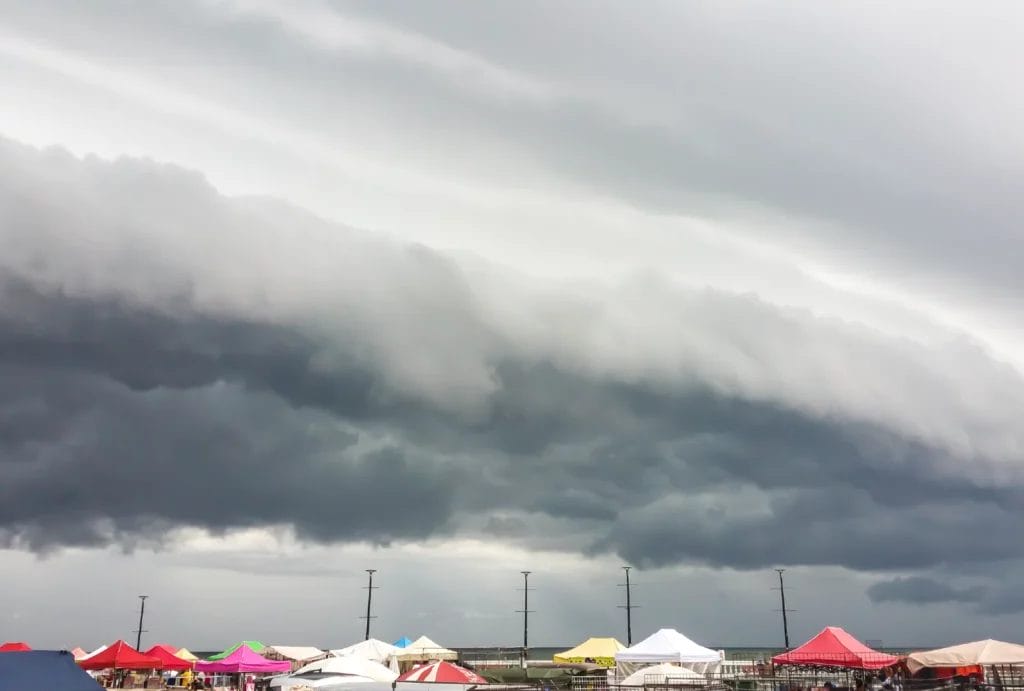 cloudy sky over an outdoor market with colorful tents