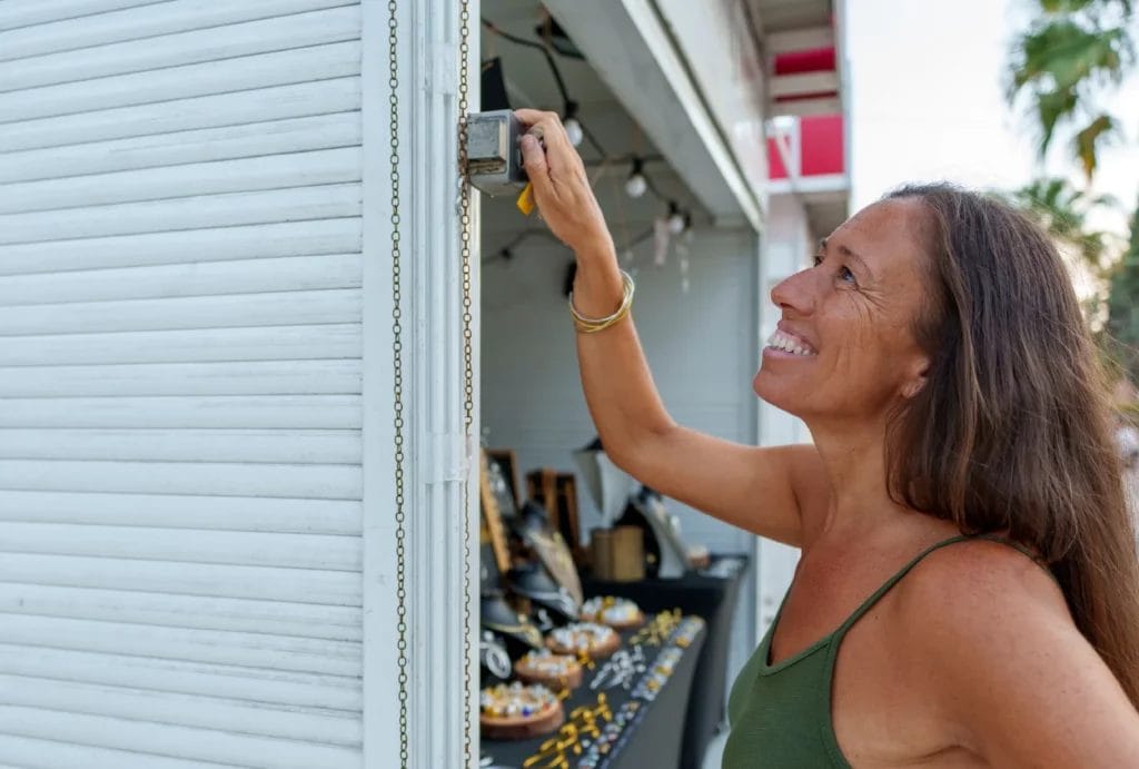 a jewelry vendor opening her market stall to sell handmade jewelry