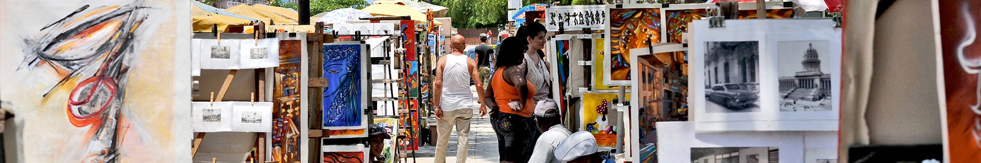 A man is seen walking down the street at an outdoor fair.