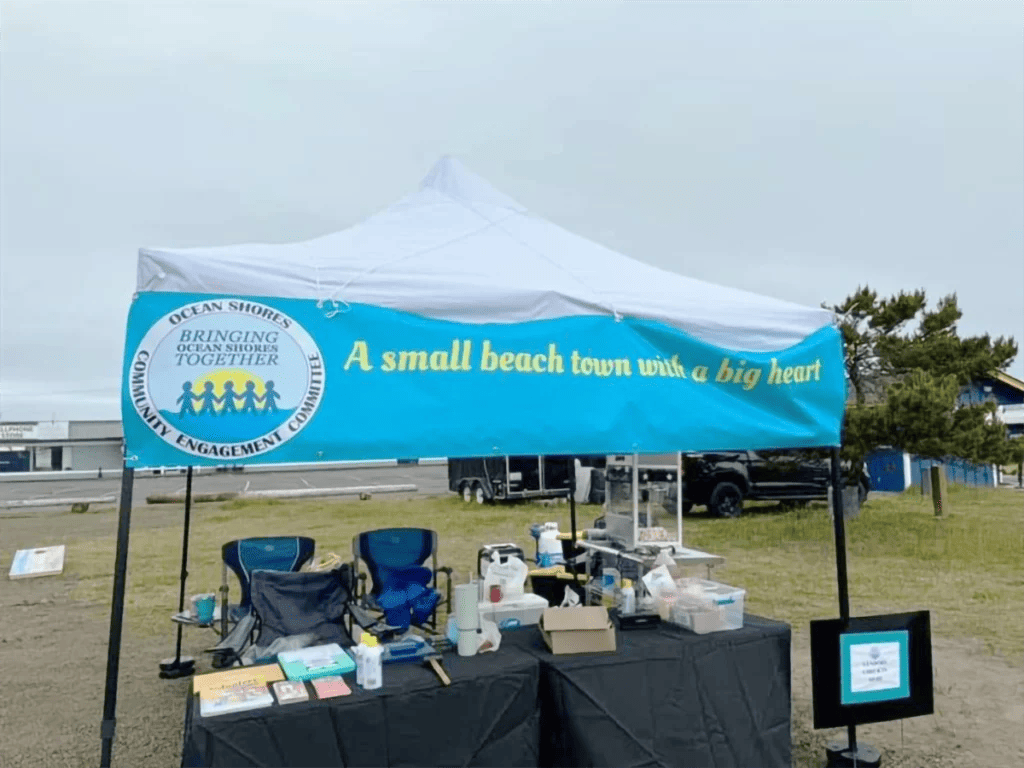 The Ocean Shores Community Engagement Committee’s vendor booth, where they provide support to vendors and keep an eye on their event at all times.