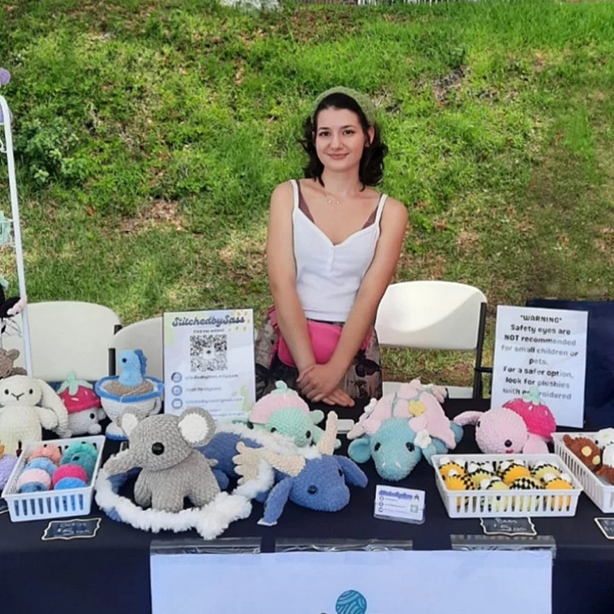 Sass at her booth selling crocheted items at a local craft fair.