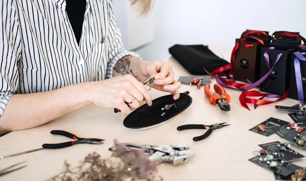 Jewelry artisan crafting handmade accessories at a workshop.