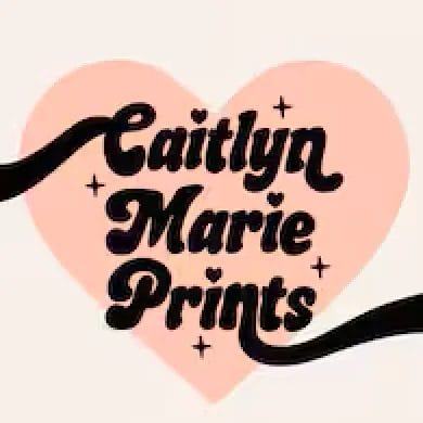 A pink and black logo depicting a sparkling heart with text that reads, "Caitlyn Marie Prints."