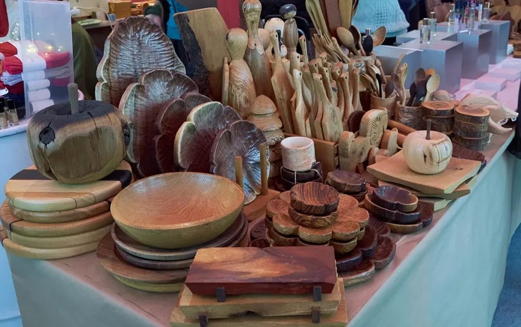 Wood crafts on a vendor table.