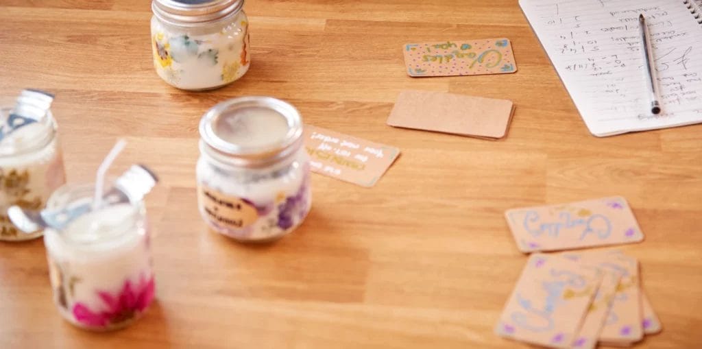 handmade floral candles with handwritten labels and tags
